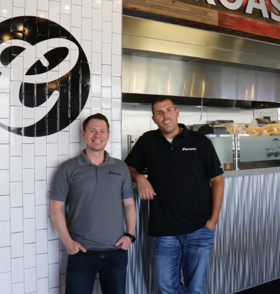 Ashley Morris and Jason Smylie standing in front of Capriotti's counter