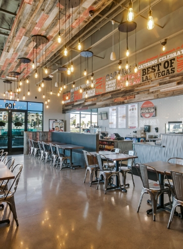 tables with metal chairs inside a restaurant