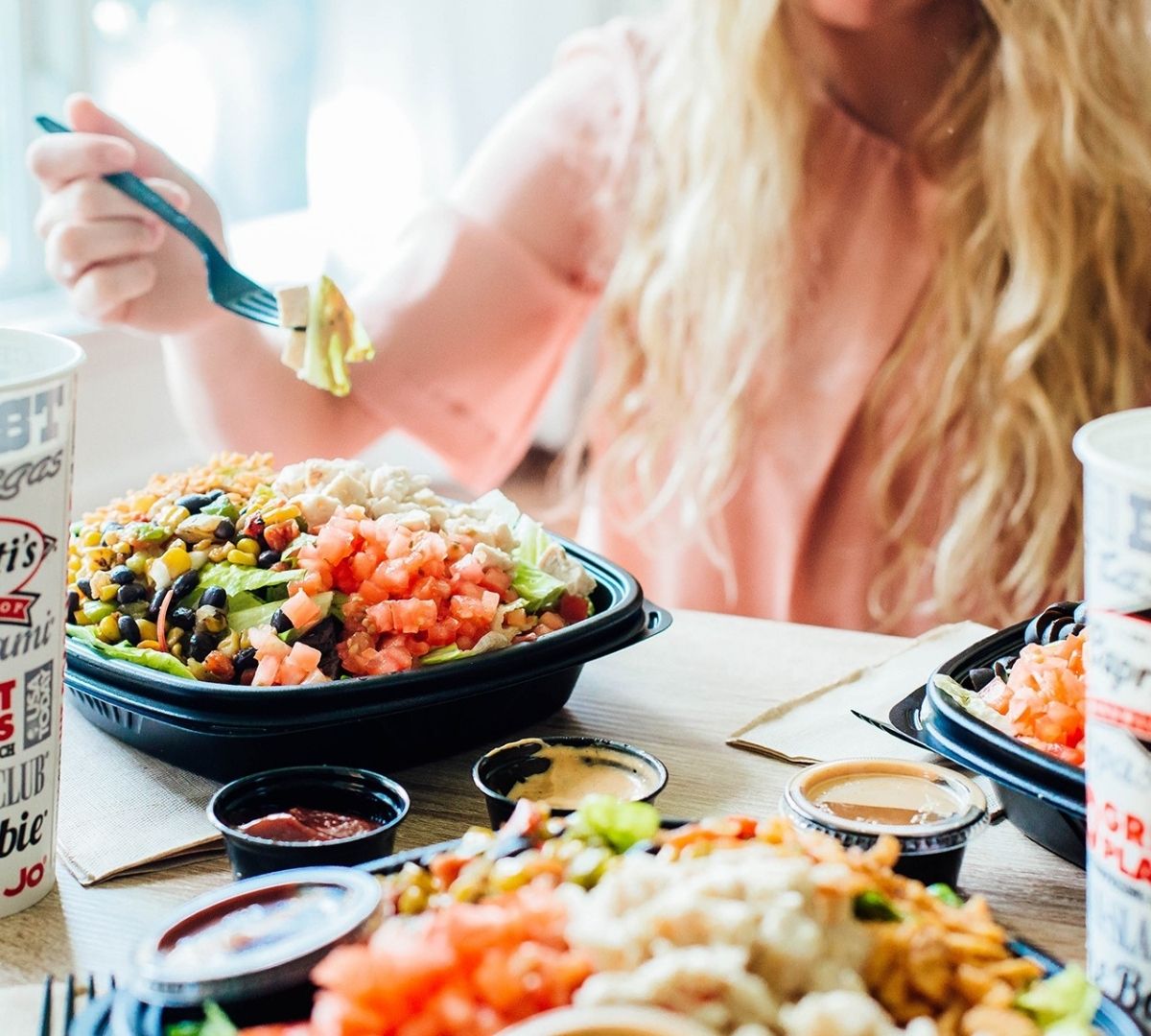 Woman eating Capriotti's salad 