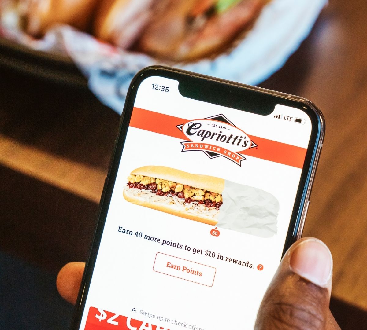 Person using the Capriotti's app